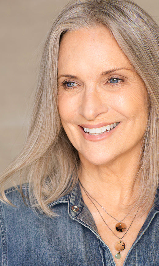 Robin, KINDri’s creator, smiling in a denim shirt