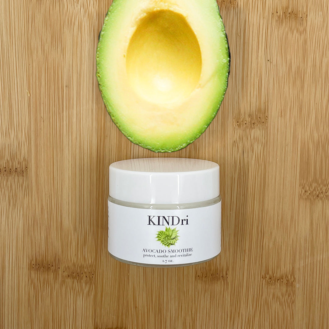 Avocado Smoothie moisturizer with a freshly halved avocado on wood